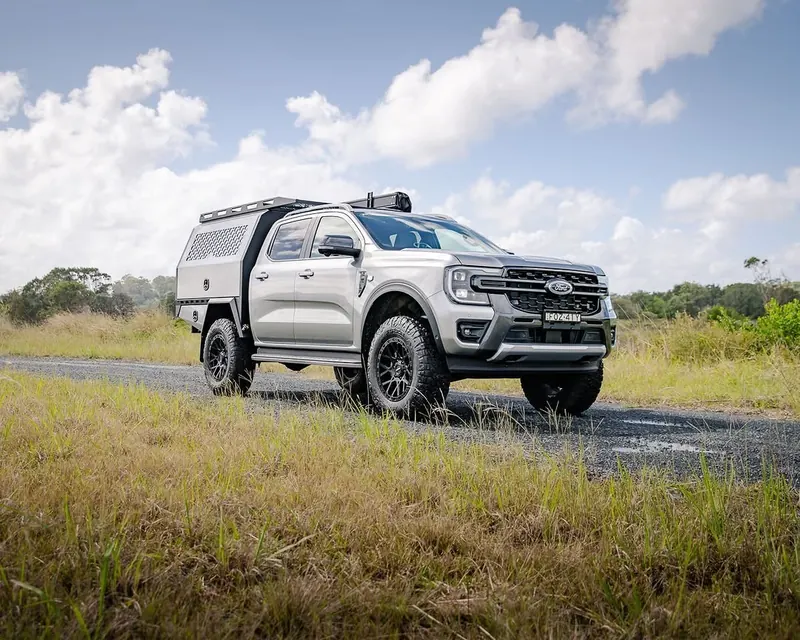 Silver Ford Ranger with custom canopy and integrated roof rack system