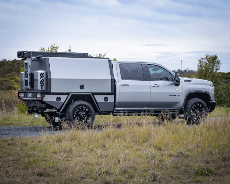 Silver Chevrolet Silverado 2500HD with custom hybrid service body in outdoor setting